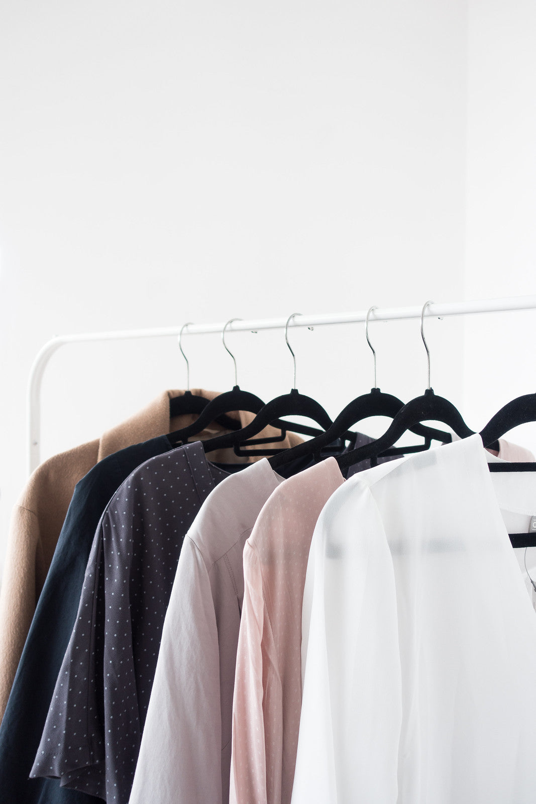 Row of clothes on hangers against a white background